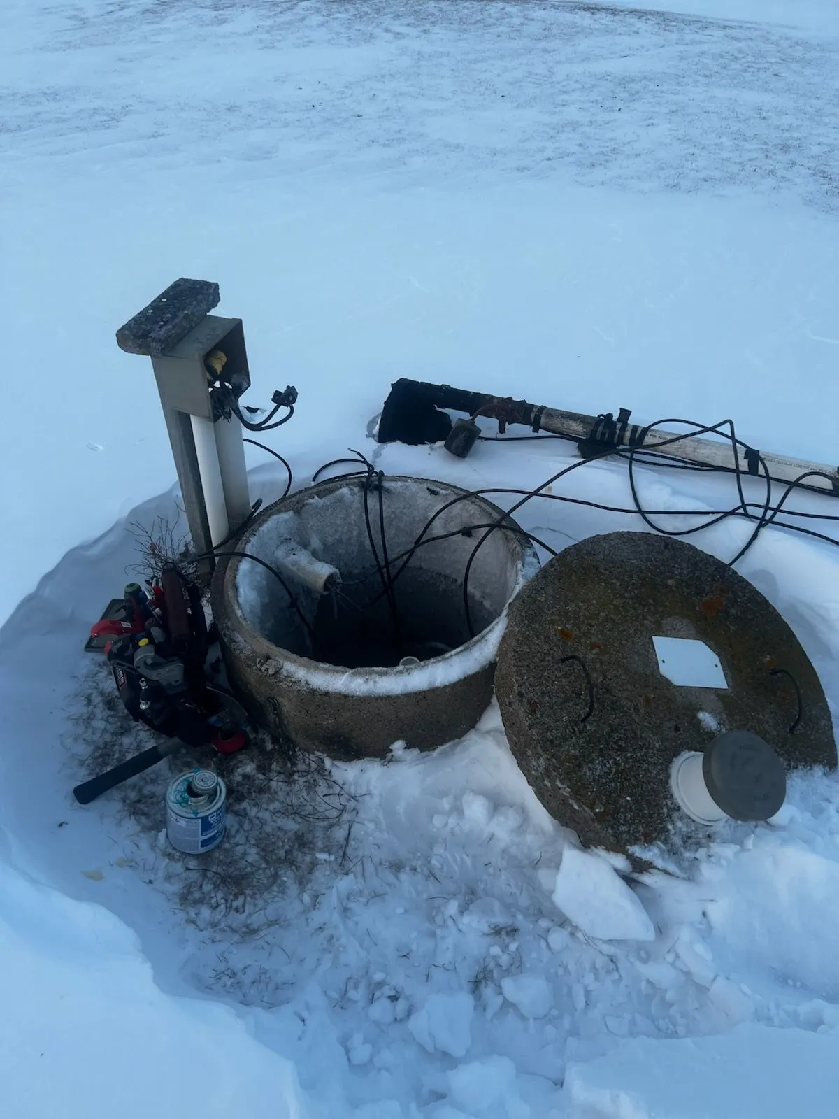 Winter septic service on snow-covered tank
