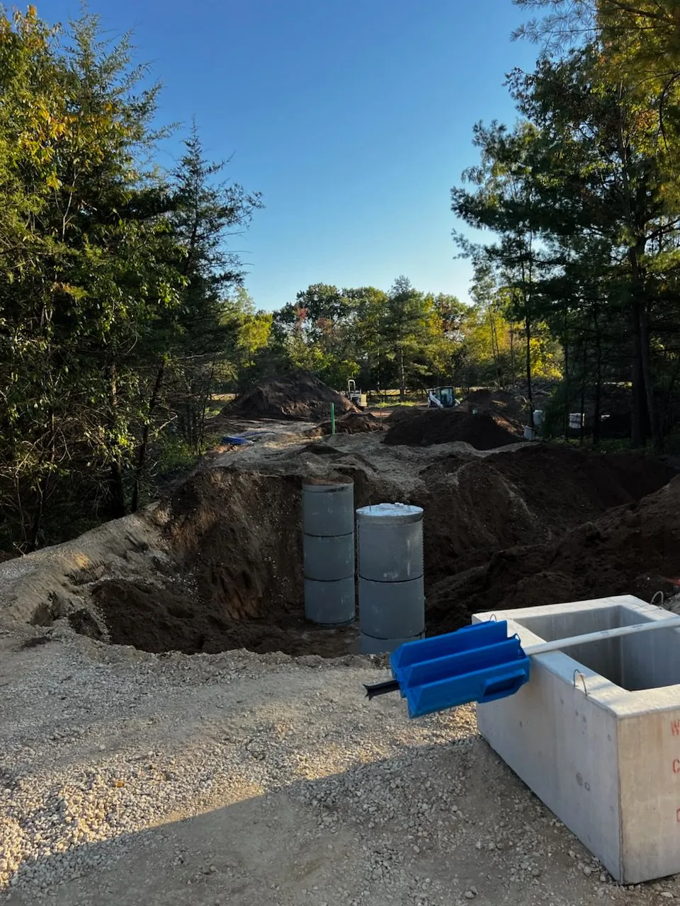 Septic tanks staged for installation in wooded site